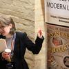 Dr Catherine Charlwood stands in front of the Diseases of Modern Life Banner